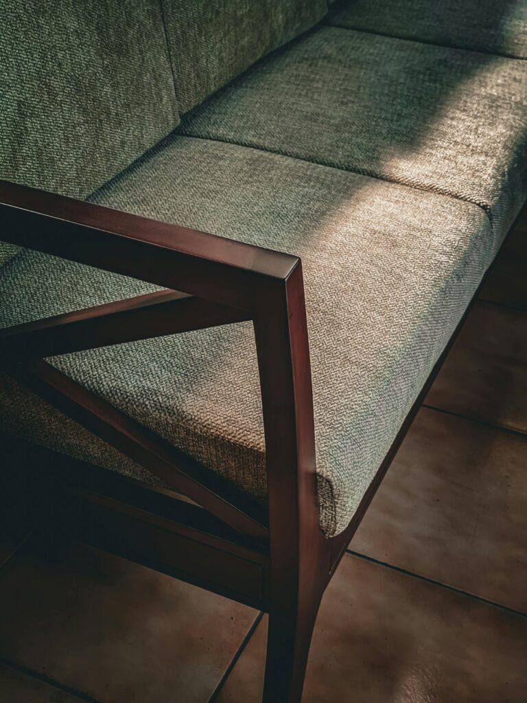 Mid century modern sofa with tapered wooden legs in a warm Canadian living room