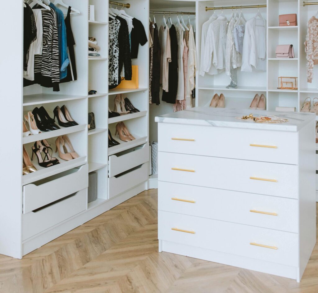 Best wardrobe for small bedroom no closet Canada showing a tall narrow white wardrobe in a minimal Canadian bedroom with hardwood floors