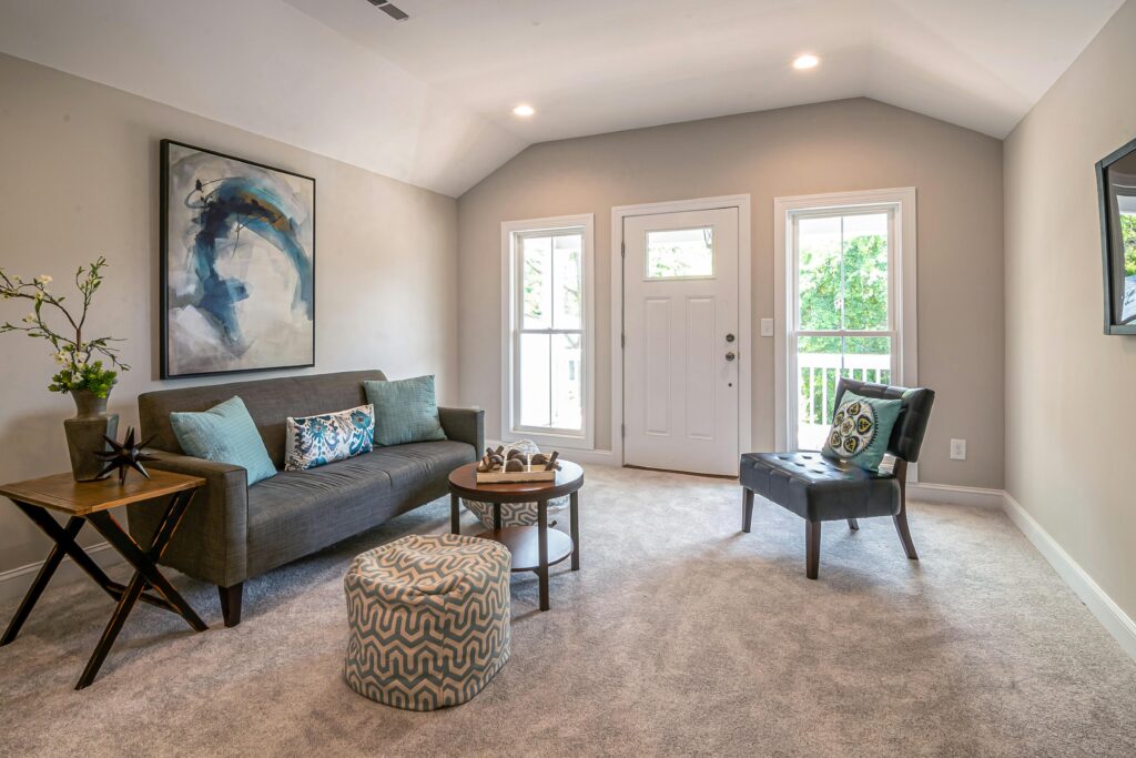 How to layout furniture in a small living room showing a bright Toronto condo with a floating compact sofa accent chair and round coffee table arrangement