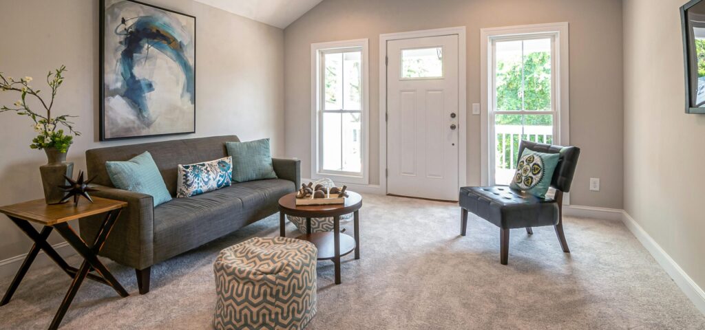 How to layout furniture in a small living room showing a bright Toronto condo with a floating compact sofa accent chair and round coffee table arrangement
