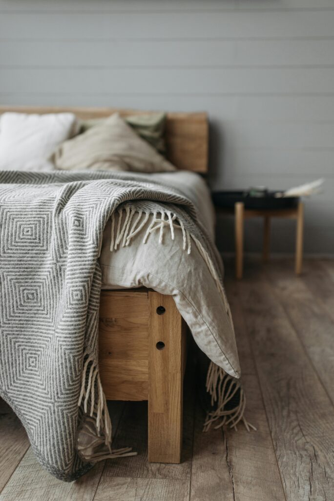 How to buy a bed frame that lasts Canada showing a solid oak platform bed in a bright minimal Canadian master bedroom