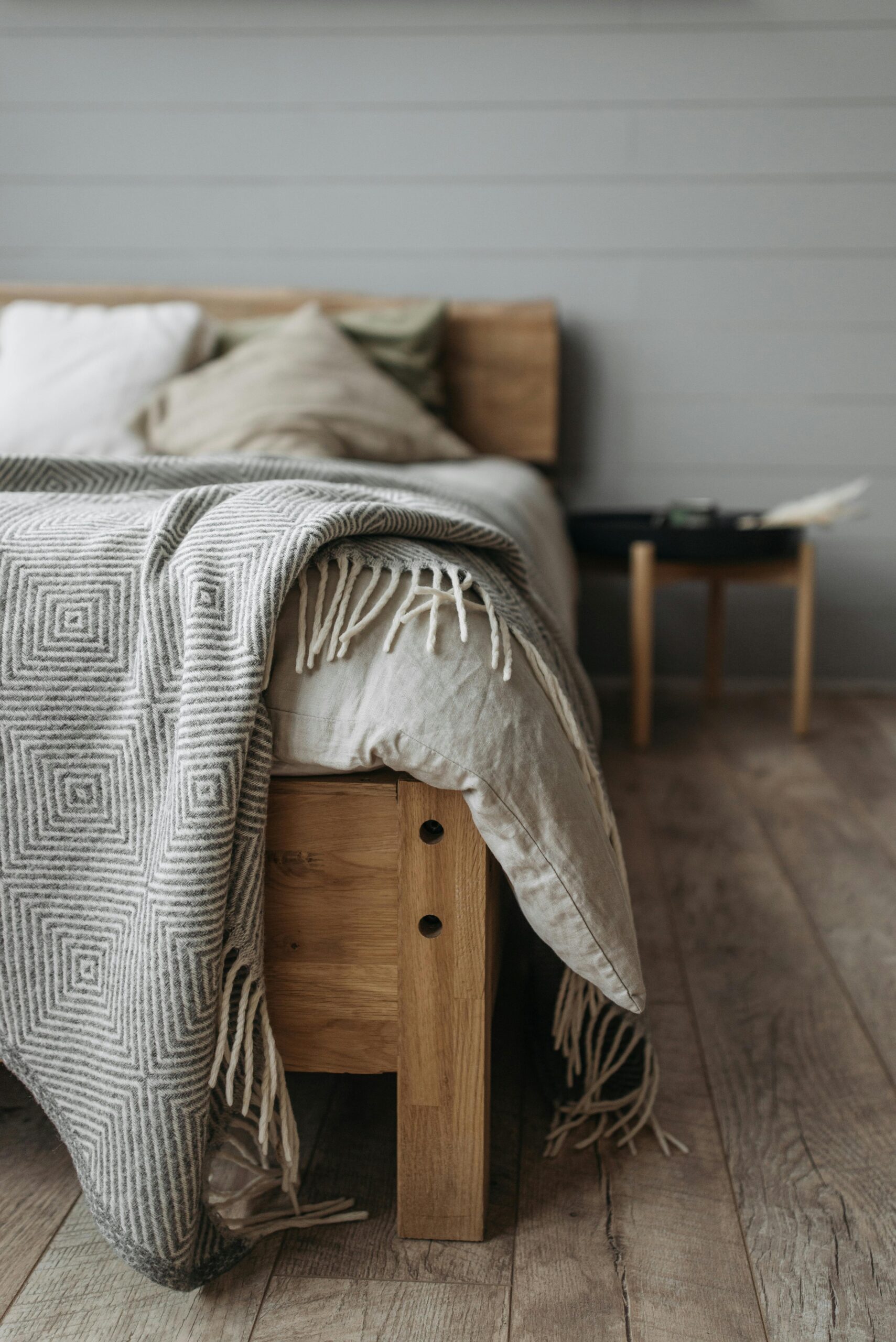 How to buy a bed frame that lasts Canada showing a solid oak platform bed in a bright minimal Canadian master bedroom
