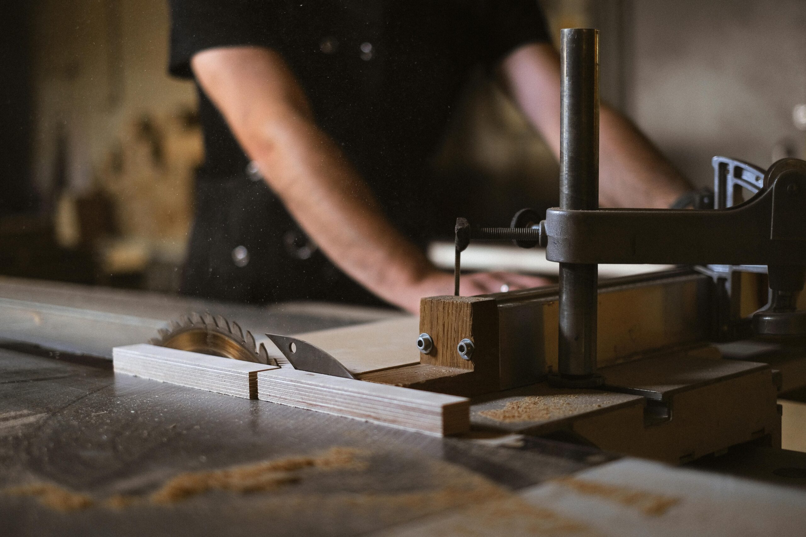 How to find local furniture makers Ontario Canada showing a craftsman finishing a solid oak dining table in a warm Ontario wood workshop